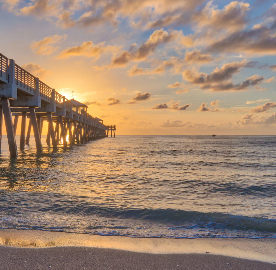 Juno Beach pier and Atlantic Ocean shoreline near Caretta new construction condos Palm Beach County FL